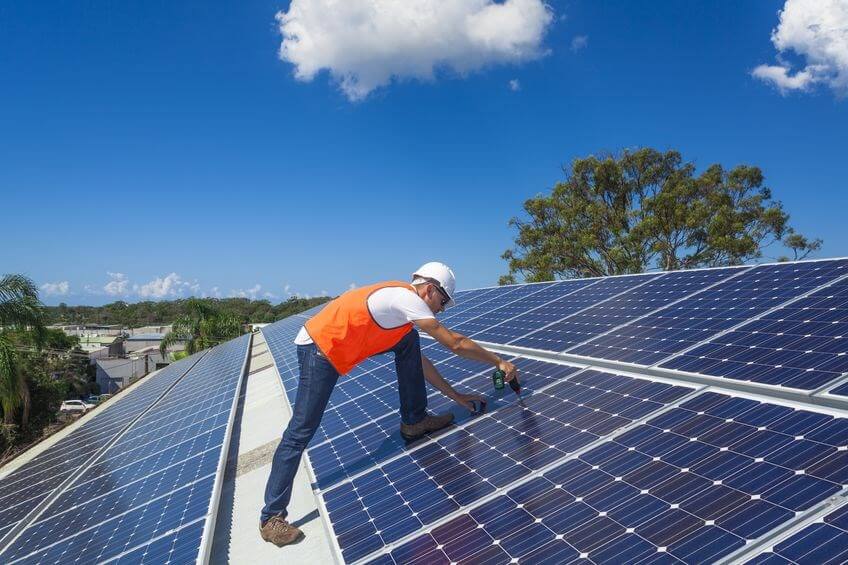 Man working on solar panels on a sunny morning