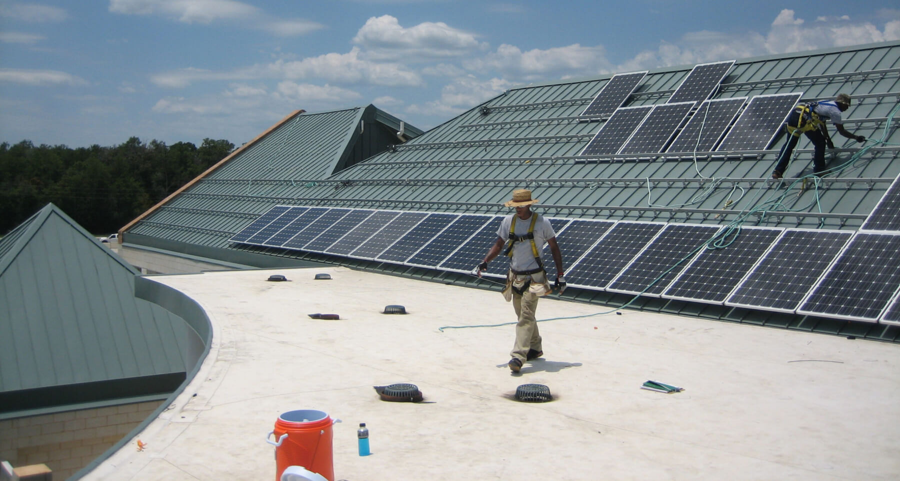 Workers installing solar panels on the roof